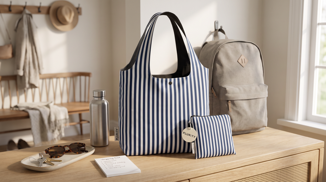 PLURiTy roll-up reusable tote beside keys and everyday essentials in an organized entryway.