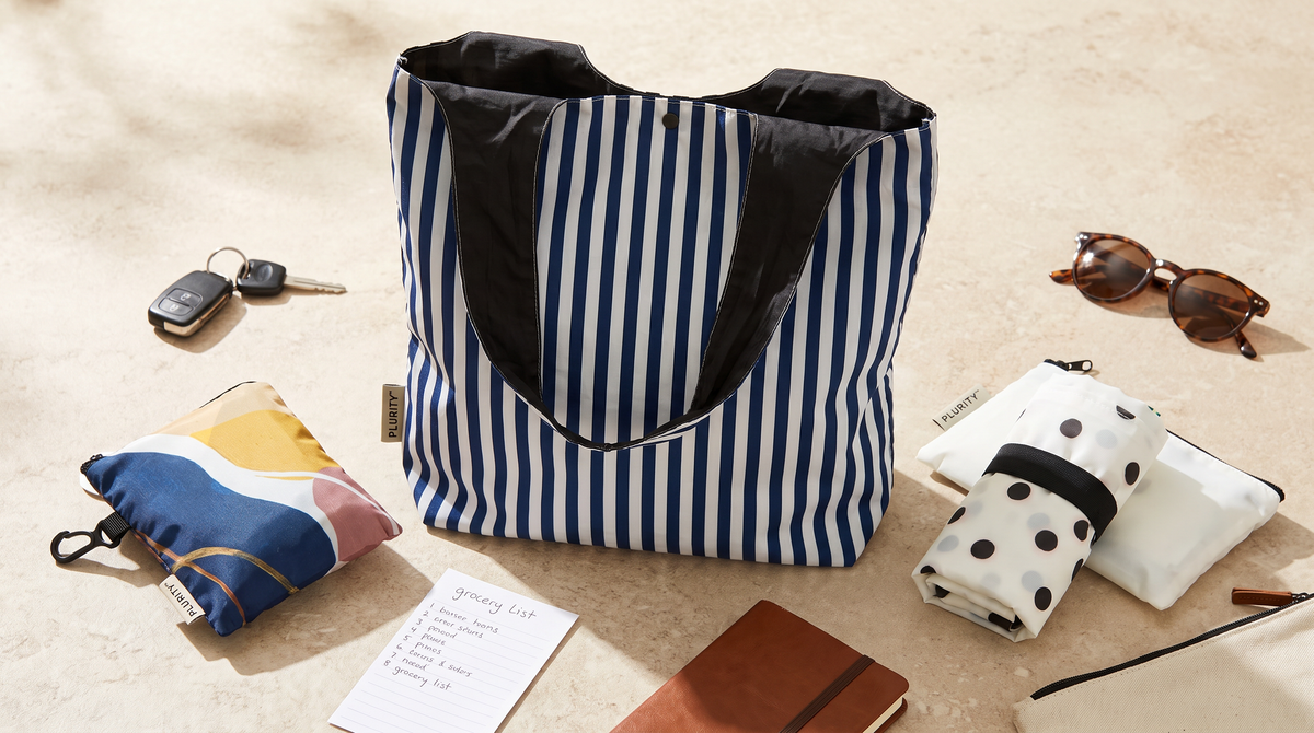 A small organized collection of PLURiTy roll-up reusable totes and coordinating storage pouches.