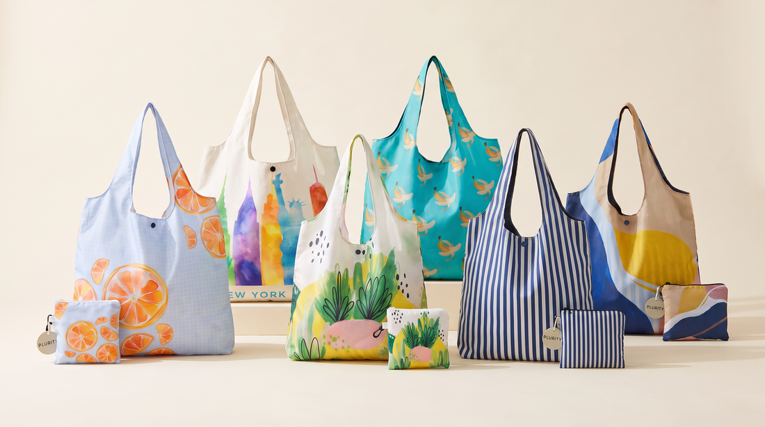 Six colorful PLURiTy roll-up reusable tote designs displayed with their coordinating compact storage pouches.